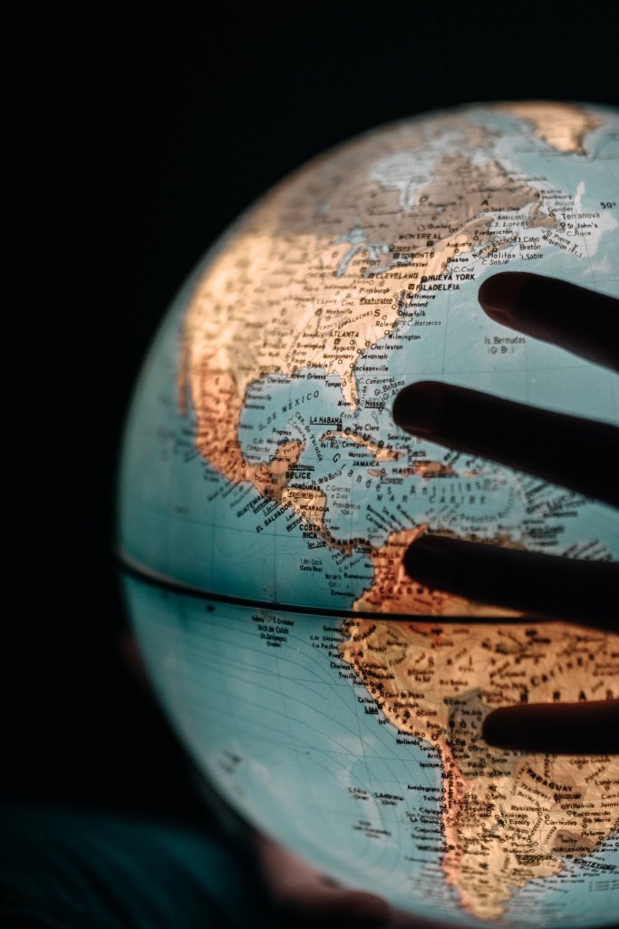 A hand holding a light up globe. 