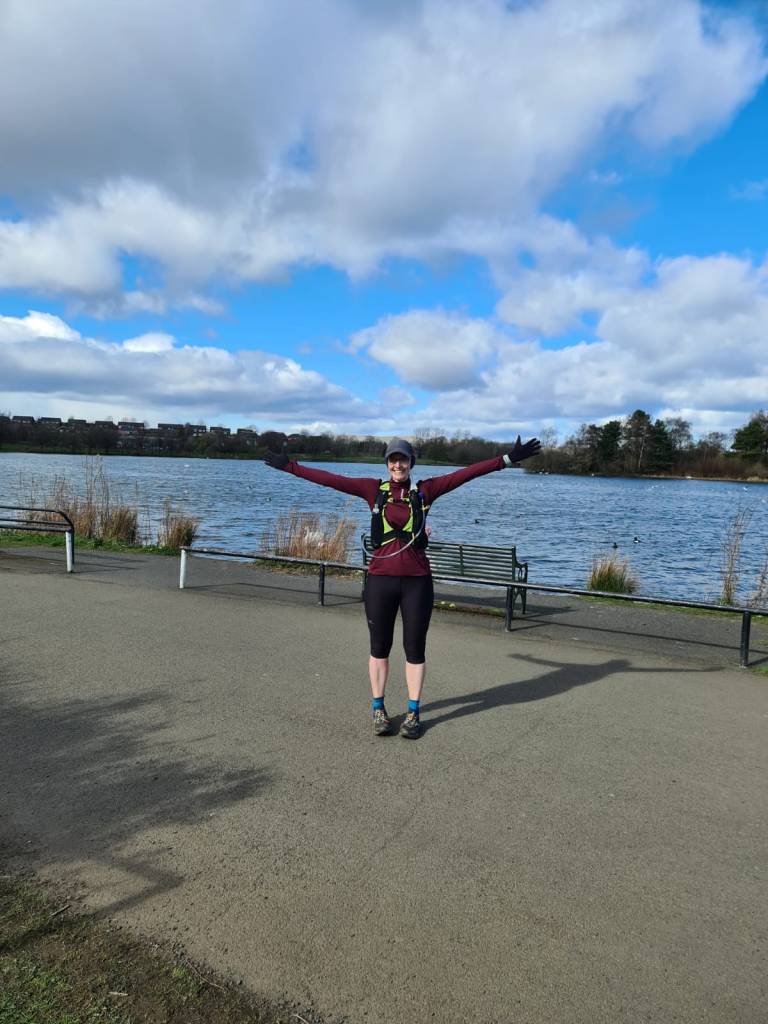 Me after a long run at Hogganfield loch - arms in the air smiling brightly. 
