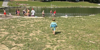 the small pond by Lac du Montriond with families. My son heading towards it in full gear.